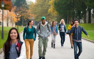 Group of college students walk across campus