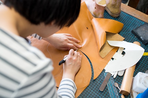 Person cutting leather