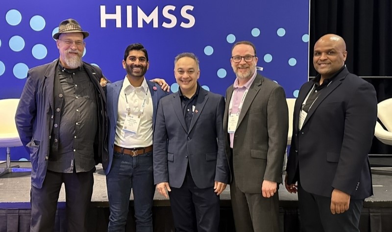 Dr. Shah standing with group of people at HIMMS ASTHO event.