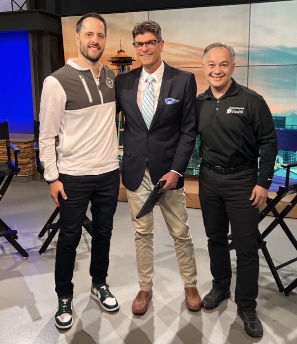 Dr. Shah poses with journalists at the Fox 13 studio.