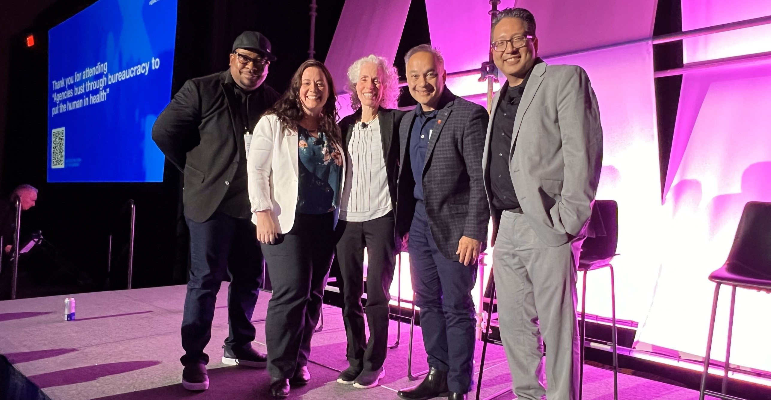 Dr. Shah posing with a group at the Qualtrics X conference.