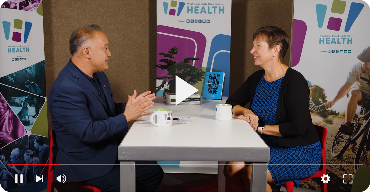 Dr. Este Geraghty talking with Dr. Umair Shah at a table.