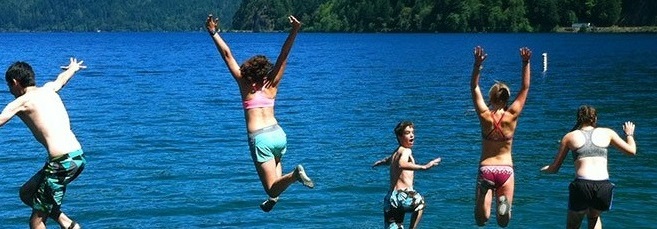 Kids jumping into a lake.