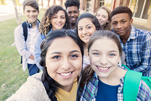 group of teens smiling in a selfie photo