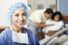 Image of nurse with couple in background