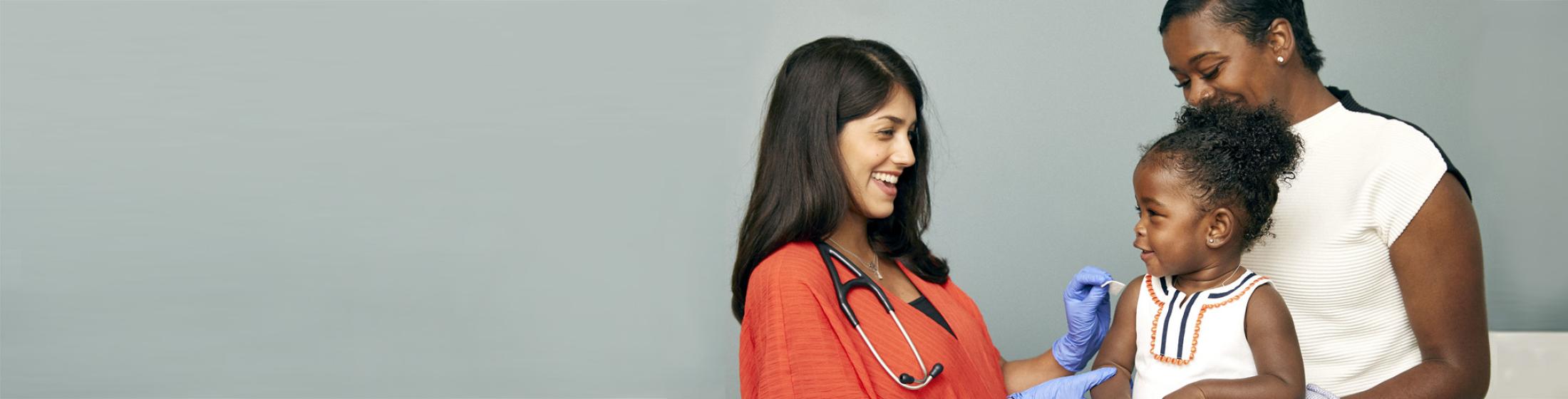 Child getting vaccinated by doctor
