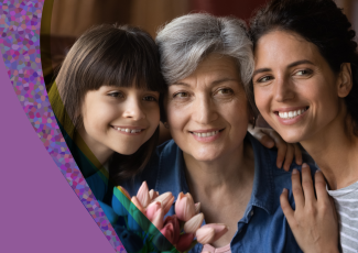 A daughter, grandmother, and mother pose for a picture.